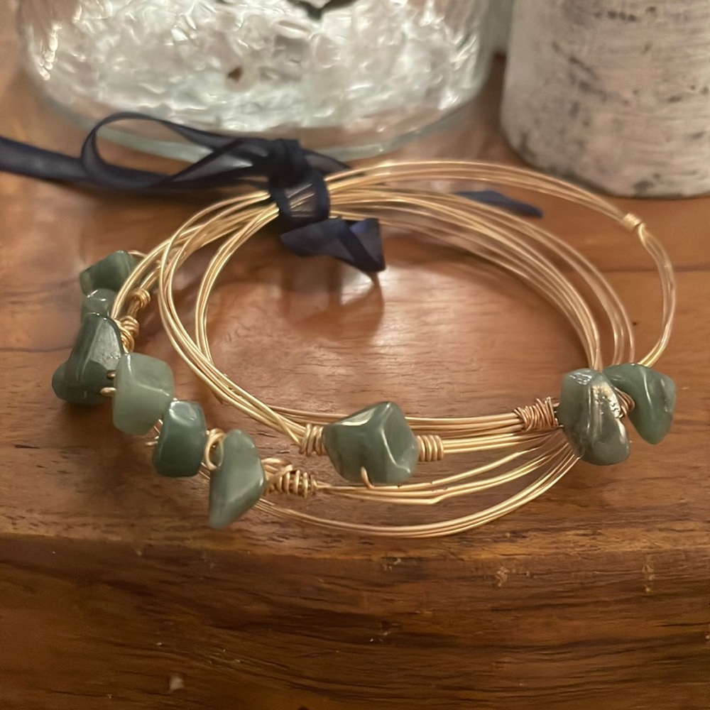 Gold tone bangles with natural green stones